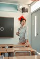 A woman sitting at a desk in a classroom.