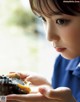 A young boy holding a shell in his hands.