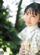 A woman in a plaid shirt is posing for a picture.